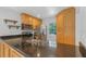 Bright kitchen featuring stainless steel appliances and black countertops at 9050 Lake Place Ln, Tampa, FL 33634