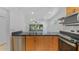 Open-concept kitchen featuring wooden cabinets and stainless steel appliances at 9050 Lake Place Ln, Tampa, FL 33634