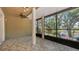Enjoy this covered lanai with tiled flooring and a screened enclosure overlooking a peaceful pond at 9050 Lake Place Ln, Tampa, FL 33634