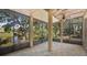 Relaxing screened lanai featuring tile flooring and picturesque views of the tranquil pond at 9050 Lake Place Ln, Tampa, FL 33634