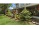 Landscaped backyard featuring a brick patio, screened in lanai and mature landscaping at 9050 Lake Place Ln, Tampa, FL 33634