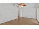 Empty living room with neutral walls, ceiling fan, and wood-look floors at 9050 Lake Place Ln, Tampa, FL 33634