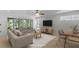 Bright, virtually staged living room featuring modern furniture and natural light at 9050 Lake Place Ln, Tampa, FL 33634