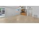 Spacious living room area next to the kitchen and featuring tile flooring at 9050 Lake Place Ln, Tampa, FL 33634