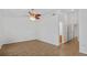 Spacious living room with wood floors, ceiling fan, and access to another room at 9050 Lake Place Ln, Tampa, FL 33634