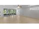 Bright living room with large windows, neutral walls, and tile flooring at 9050 Lake Place Ln, Tampa, FL 33634