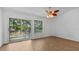 Bright and airy bedroom with balcony access and wood flooring at 9050 Lake Place Ln, Tampa, FL 33634