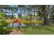 Scenic view of a pond surrounded by lush greenery and trees in a serene setting at 9050 Lake Place Ln, Tampa, FL 33634