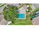 Overhead shot of a community pool featuring an expansive sundeck and landscaping at 9050 Lake Place Ln, Tampa, FL 33634