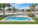 Community pool with lounge chairs, a bathhouse, and a well-kept lawn at 9050 Lake Place Ln, Tampa, FL 33634