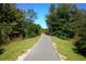 Picturesque walking path leading to a wooden bridge, surrounded by lush greenery at 9443 Raised Tulip Ln, Land O Lakes, FL 34637
