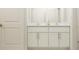 Bright bathroom vanity with a quartz countertop, double sinks, chrome fixtures, and modern white cabinets, a clean and elegant design at 9487 Raised Tulip Ln, Land O Lakes, FL 34637
