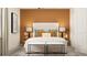 Inviting bedroom featuring a headboard, modern lamps, colorful pillows and seating, a cozy, stylish and relaxing retreat at 9487 Raised Tulip Ln, Land O Lakes, FL 34637