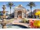 Club Connerton clubhouse exterior featuring brick facade, white columns, fountain, and meticulously landscaped entrance at 9487 Raised Tulip Ln, Land O Lakes, FL 34637