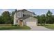Charming two-story home featuring mixed siding, manicured lawn, and an attached two-car garage, and professional landscaping at 9487 Raised Tulip Ln, Land O Lakes, FL 34637