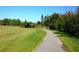 Scenic path surrounded by lush greenery, ideal for walking and enjoying nature at 9487 Raised Tulip Ln, Land O Lakes, FL 34637