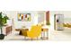 Living room with stainless steel refrigerator, contemporary artwork, and comfortable yellow seating at 9711 Minnow Ray Dr, Land O Lakes, FL 34638
