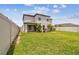 Spacious fenced backyard with a well-maintained lawn and a covered patio at 1009 Wynnmere Walk Ave, Ruskin, FL 33570