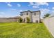 A beautifully maintained lawn surrounds this two-story home in a fenced backyard, enhancing privacy and outdoor space at 1009 Wynnmere Walk Ave, Ruskin, FL 33570