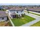 An aerial shot of a two-story home and large green backyard bordered by a white fence enhances the property's spacious appeal at 1009 Wynnmere Walk Ave, Ruskin, FL 33570