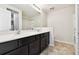 Bright bathroom featuring a double vanity with a quartz countertop and modern fixtures at 1009 Wynnmere Walk Ave, Ruskin, FL 33570