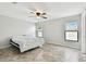 Bright bedroom with tile floors and two windows letting in natural light with a ceiling fan at 1009 Wynnmere Walk Ave, Ruskin, FL 33570