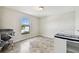 Neutral bedroom showcasing tile flooring, a window, and baby furniture at 1009 Wynnmere Walk Ave, Ruskin, FL 33570