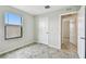 Neutral bedroom showcasing tile flooring, a window, and a white door at 1009 Wynnmere Walk Ave, Ruskin, FL 33570