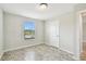 Neutral bedroom featuring a window, tile flooring, and a white door at 1009 Wynnmere Walk Ave, Ruskin, FL 33570