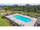 The sparkling community pool with comfortable lounge chairs and a playset nearby offers relaxation and play in a natural setting at 1009 Wynnmere Walk Ave, Ruskin, FL 33570
