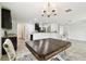 Eat-in kitchen featuring windows, modern light fixture, tile floors, and decorative chairs surrounding the table at 1009 Wynnmere Walk Ave, Ruskin, FL 33570