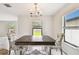 Eat-in kitchen featuring windows, modern light fixture, tile floors, and decorative chairs surrounding the table at 1009 Wynnmere Walk Ave, Ruskin, FL 33570