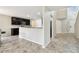 Open kitchen with dark cabinetry, granite countertops, and sleek appliances adjacent to the entryway at 1009 Wynnmere Walk Ave, Ruskin, FL 33570