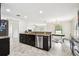 Kitchen boasts granite countertops, stainless steel appliances, dark cabinetry, and a tile backsplash at 1009 Wynnmere Walk Ave, Ruskin, FL 33570