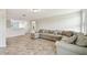 Well-lit living room displaying a large sectional sofa and an open floor plan at 1009 Wynnmere Walk Ave, Ruskin, FL 33570