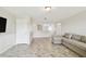 Open living room featuring stylish tile flooring and comfortable seating near a well-lit area at 1009 Wynnmere Walk Ave, Ruskin, FL 33570