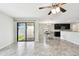 Open-concept living room features tile floors, sliding glass doors to the patio, and views of the kitchen at 1009 Wynnmere Walk Ave, Ruskin, FL 33570