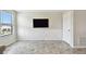 Modern living room featuring decorative wall paneling, sleek tile flooring, and a large window at 1009 Wynnmere Walk Ave, Ruskin, FL 33570