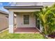 Covered patio featuring a concrete floor, a window, and tropical landscaping at 1009 Wynnmere Walk Ave, Ruskin, FL 33570
