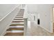Elegant staircase leading to an open living area, featuring wood treads and white risers at 1009 Wynnmere Walk Ave, Ruskin, FL 33570