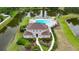 Aerial view of community center with a sparkling pool and scenic pond views at 10412 Tara Dr, Riverview, FL 33578