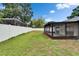 The backyard features a well-maintained lawn, a privacy fence, and a screened-in lanai at 10412 Tara Dr, Riverview, FL 33578