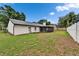 The spacious backyard has a well-maintained lawn, a wooden fence, and mature trees at 10412 Tara Dr, Riverview, FL 33578