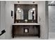 Stylish bathroom featuring a dual sink vanity, elegant mirrors, and modern lighting fixtures at 10412 Tara Dr, Riverview, FL 33578