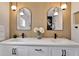 Modern bathroom with double sinks, black fixtures, modern lighting and textured wallpaper at 10412 Tara Dr, Riverview, FL 33578