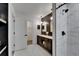 Beautiful bathroom featuring a marble shower and elegant dark wood vanity with dual sinks at 10412 Tara Dr, Riverview, FL 33578