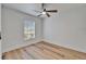 Bedroom showcasing hardwood floors, neutral paint, ceiling fan, and a bright window at 10412 Tara Dr, Riverview, FL 33578