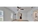 Spacious bedroom features wood floors, modern fan and bathroom en suite at 10412 Tara Dr, Riverview, FL 33578