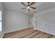 Bedroom with hardwood floors, ceiling fan and spacious closets at 10412 Tara Dr, Riverview, FL 33578