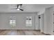 Bright and airy bedroom with wood flooring, shuttered windows, and a spacious closet at 10412 Tara Dr, Riverview, FL 33578
